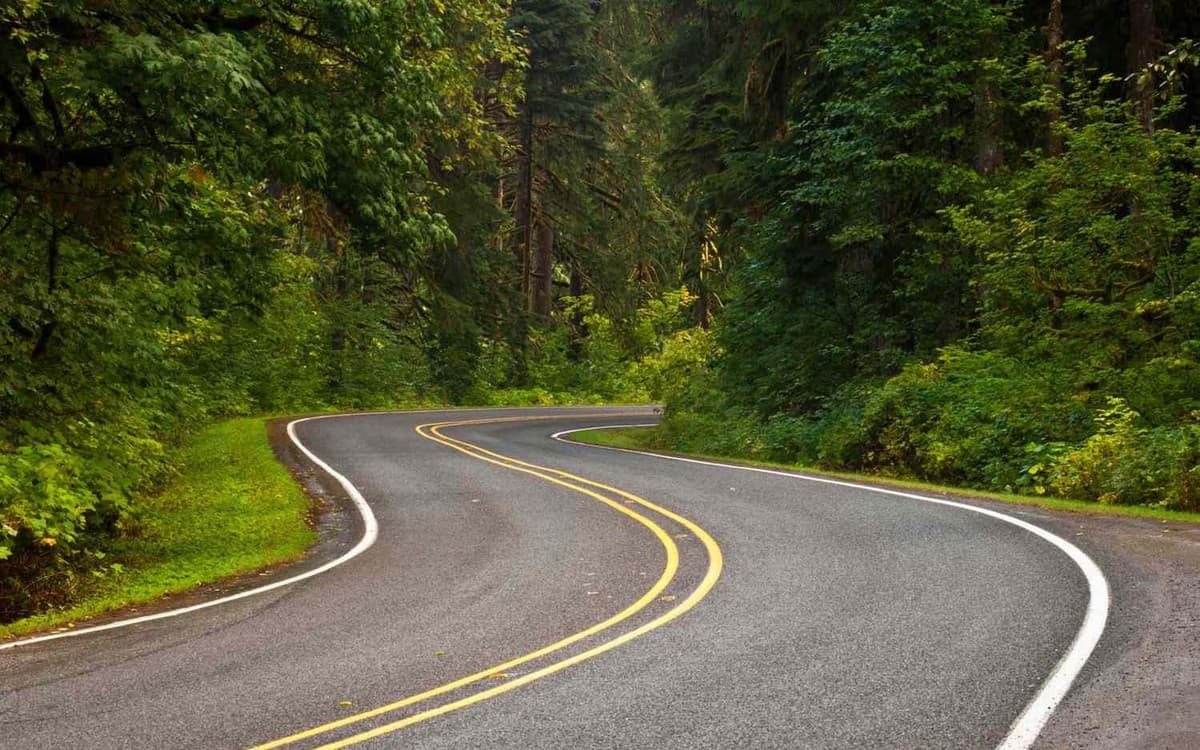 Winding mountain road representing cross country vehicle shipping routes
